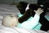 Libby wrestling a Teddy bear from Aunt Tristan