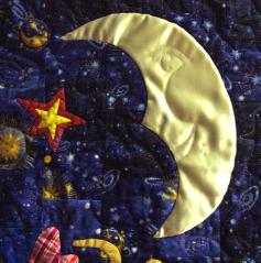 detail of face quilted into the moon